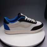 Side view of the Ventela V-88 Low in white, black and blue with a cream sole
