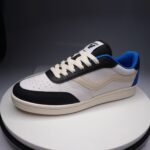 Three-quarter front view of the Ventela V-88 Low in white, black and blue